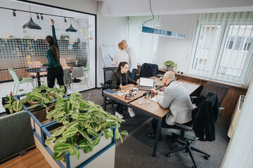 Group of associates engaged in team collaboration and brainstorming in a bright and spacious office space, focusing on daily tasks and sharing ideas.