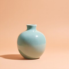 A light blue ceramic vase with a narrow neck sitting on a peach colored surface in soft lighting