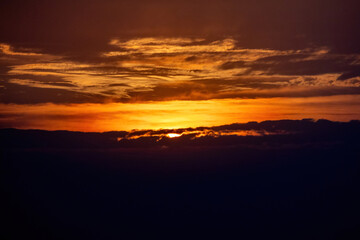 Obraz premium Dramatic sunset sky with stunning clouds at evening. Fiery red background before sunset.