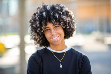 Teen girl with vitiligo smiling with confidence in natural light