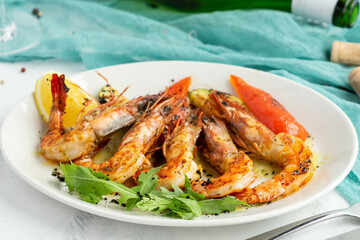 Grilled shrimp plate with vegetables and lemon garnish on rustic table setting