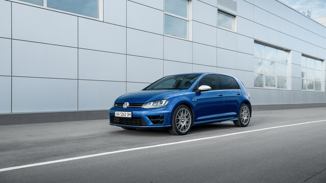 blue Volkswagen Golf R in front of grey building wall. Three quarter front view of sporty VW Golf mk7 hatchback. Kyiv, Ukraine - April 03 2016