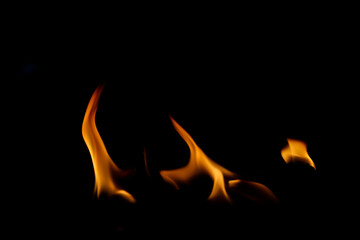 Flames Dancing in Darkness with Vibrant Orange and Yellow Hues