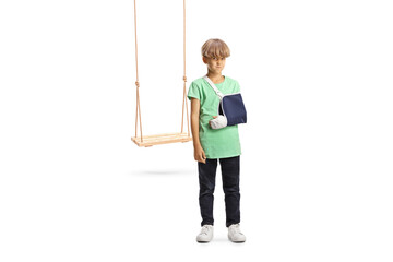 Sad boy with a broken arm wearing an arm splint, injured from a swing fall