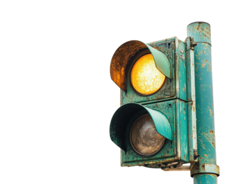 Traffic Light on Amber: A weathered, old traffic light emits a cautionary amber glow, standing as a steadfast guardian of safety and order on the thoroughfare.