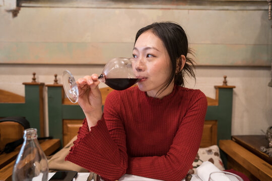 Asian tourist enjoying wine in Segovia setting