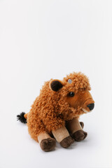 Bison stuffed animal sitting on a white background
