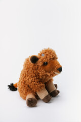 Bison stuffed animal sitting on a white background