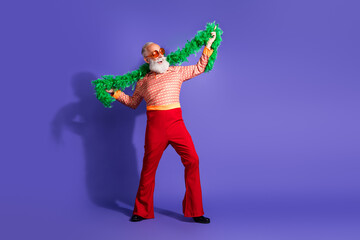 Eccentric senior gentleman posing with a retro outfit against a vibrant purple backdrop, embodying charm, style, and vintage flair