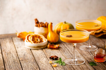 Pumpkin and orange spiced fall cocktail with cinnamon