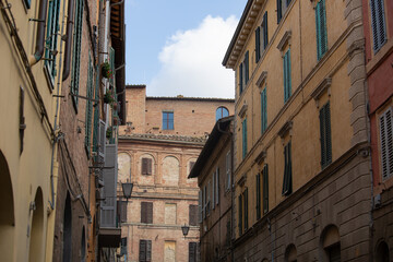 Old orange building wall with windows in the old europe city on the street. Italy town with vintage style