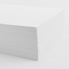 A close up shot of a stack of white paper sheets with a plain background in a studio setting view