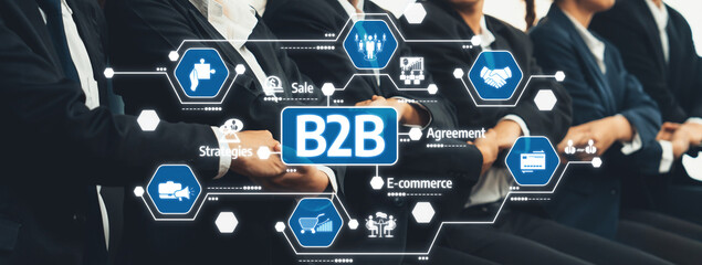 A professional setting showcases individuals in business attire engaging in B2B activities, focusing on collaboration, e-commerce strategies, and partnership agreements for growth. Amity