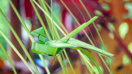 Making woven and handicrafts from coconut leaves (janur). Recycled handicrafts.