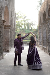 Traditional Indian Couple in Coordinated Purple Ethnic Outfits Outdoors