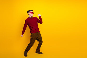 Cheerful Cheerful Young Man With Trendy Look Posing Against a Bright Yellow Background