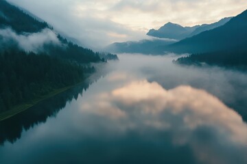 Fototapeta premium Morning fog blankets mountain lake during a serene sunrise view, Morning fog on the mountain lake, sunrise view, aerial Photo