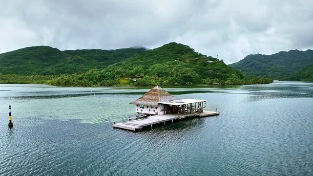 Drone Tahiti. Aerial view of Huahine island lagoon, pearl farm bungalow hut in clear ocean water. Black pearls, luxury honeymoon vacation, tourism destination in French Polynesia. 