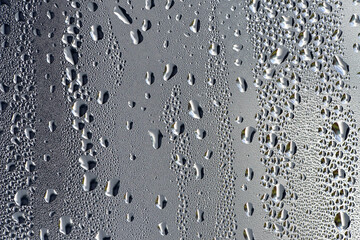 background, unusual, abstract. drops of morning dew, condensation on the glass. wet glass. water drops close-up. beautiful background for text. Spray cool condensate water on the glas