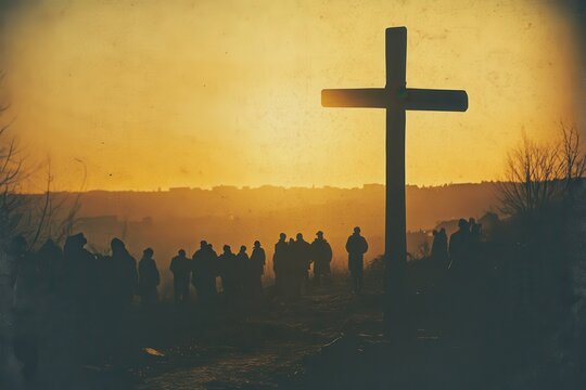 Silhouette of a large wooden cross at sunset with people gathered in the foreground, creating a serene atmosphere of reflection and remembrance