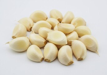 Pile of fresh garlic cloves on white background