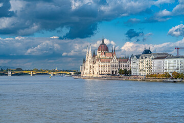 Dramatic Hungarian Parliament Building Under Stormy Sky Along Danube River in Budapest - Iconic...