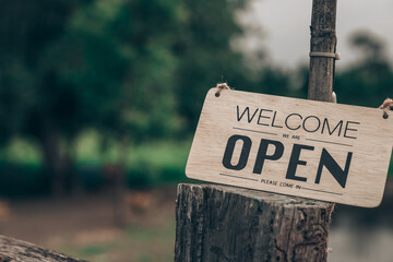 A coffee shop with a welcome sign posted through the glass door, ready to serve customers.	