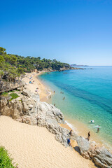 Tourists enjoying summer holidays at idyllic cala cap roig beach in calonge, costa brava, spain