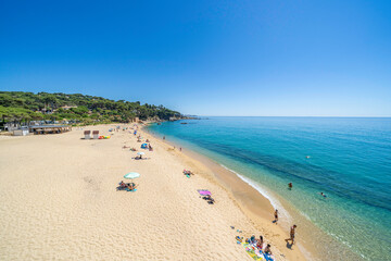 Tourists relaxing on sandy beach of costa brava in calonge, spain