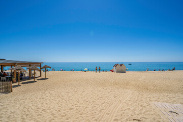 Tourists enjoying summer on the beach of calonge, costa brava, spain