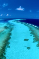 Turquoise Path in Paradise: A breathtaking aerial shot capturing the mesmerizing turquoise waters of a shallow lagoon.