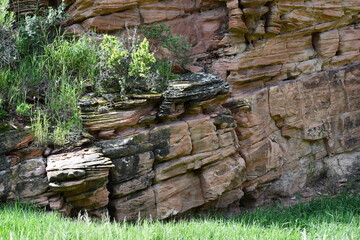 Green grass with slanted slate cliff.