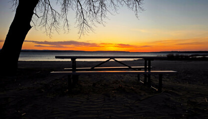Reflection of sunset on picnic table 
