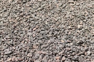 Granite crushed stone. A large pile of crushed stone for repair work. Quartzite crushed stone. Fraction. Construction material for repairing road surfaces and laying sidewalks. Background. Material
