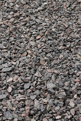 Granite crushed stone. A large pile of crushed stone for repair work. Quartzite crushed stone. Fraction. Construction material for repairing road surfaces and laying sidewalks. Background. Material