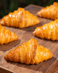Group of French Croissants in a Wooden Table Arranged Symmetrically 
