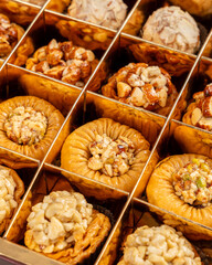 Side view of a Assorted Baklava Box Filled With Assorted Baklava Pieces in a Cross Grid Pattern 