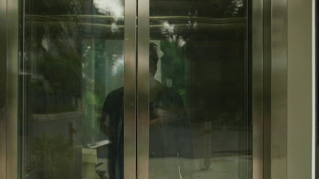 Middle-aged Caucasian man with sunglasses, going up and down elevator in parkland