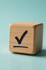 A wooden block featuring a tick mark