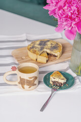 Breakfast: buckwheat tea, poppy seed cake and peonies on the table
