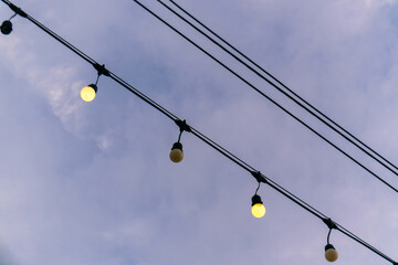 String Lights Hanging Against Twilight Sky