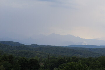 Naklejka premium green forests against the backdrop of the Caucasus Mountains in the fog