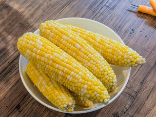 Fresh Steamed, Bicolor Ears Of Corn In A Serving Bowl On A Wooden Table