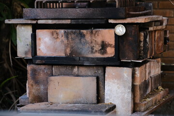 Process of baking rustic bread: Preparing the oven with coal and wood