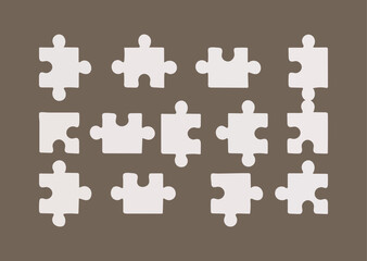 Naklejka premium Scattered Puzzle Pieces on a Brown Background for Creative Problem Solving
