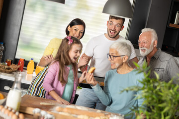 Smiling multi-generation family in kitchen