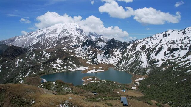 view of Haba Snow Mountain with small lake under clear skies in northern Yunnan Province, China.