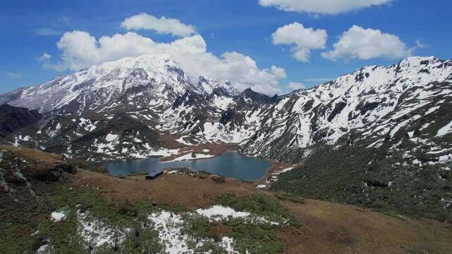 view of Haba Snow Mountain with blue lake under clear skies in northern Yunnan Province, China.