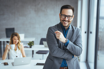 Confident Businessman Smiling in a Modern Office Environment