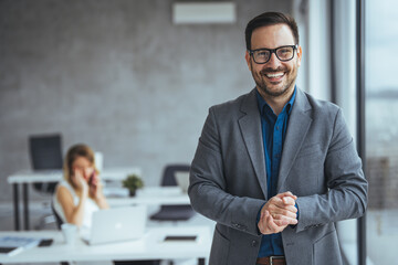 Smiling Businessman Posing in a Modern Office Environment